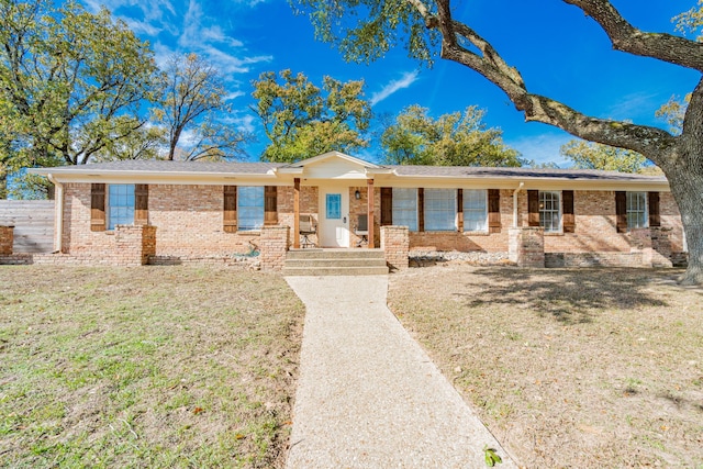 ranch-style house featuring a porch and a front lawn