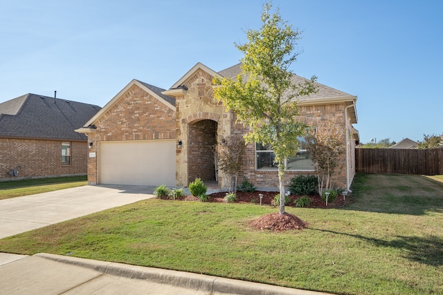 view of front of property with a garage and a front lawn