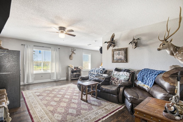 living room with a textured ceiling, hardwood / wood-style flooring, and ceiling fan