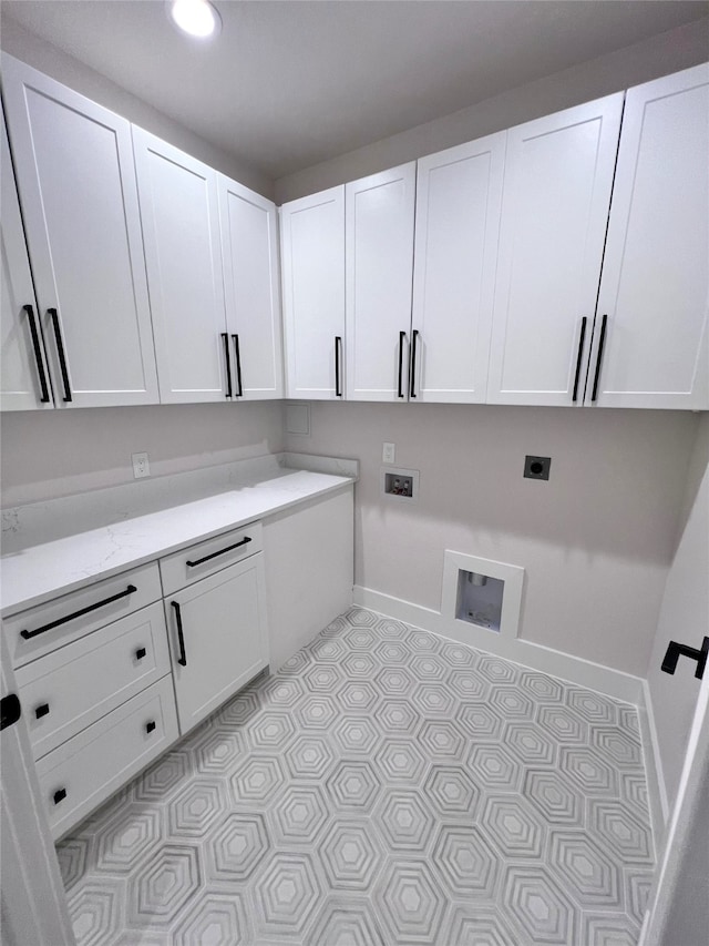 clothes washing area with cabinets, washer hookup, and hookup for an electric dryer