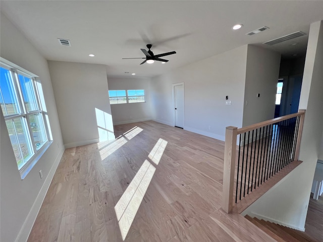 unfurnished living room featuring light hardwood / wood-style flooring and ceiling fan