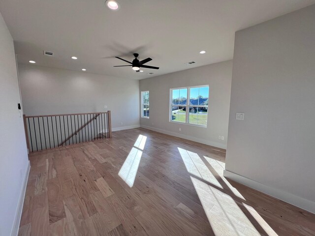 empty room featuring ceiling fan and light hardwood / wood-style flooring