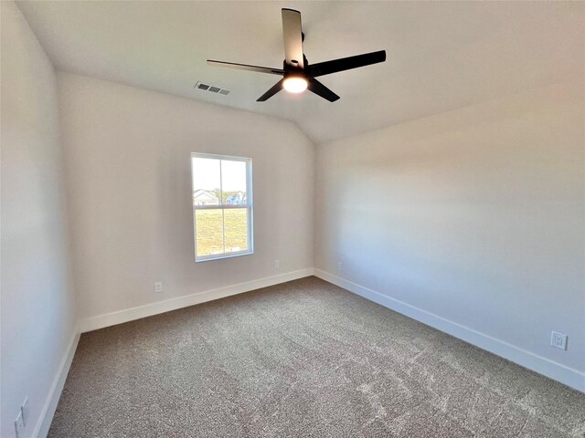 carpeted empty room featuring ceiling fan and vaulted ceiling