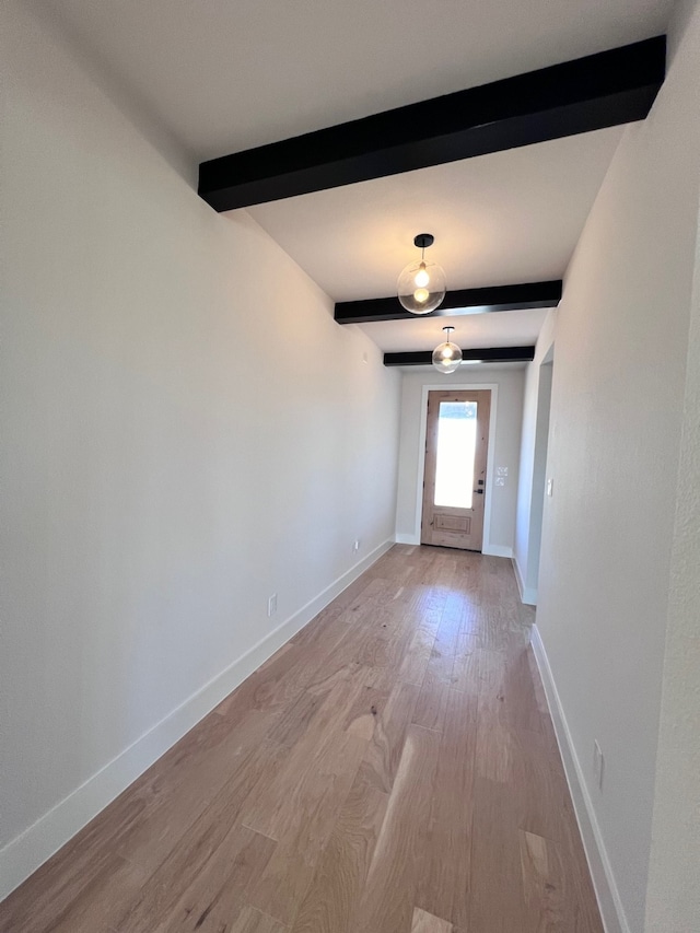 interior space with beamed ceiling and light hardwood / wood-style floors