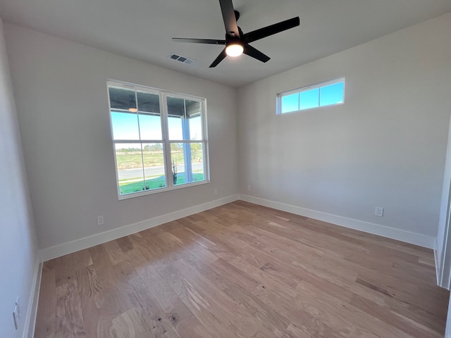 unfurnished room featuring ceiling fan, plenty of natural light, and light wood-type flooring