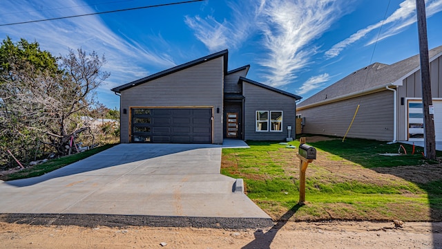 view of front of property featuring a garage and a front lawn