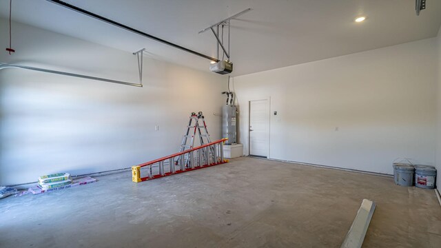 garage with electric water heater and a garage door opener