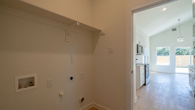 washroom with hookup for an electric dryer, washer hookup, light wood-type flooring, and gas dryer hookup