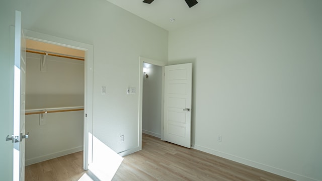 unfurnished bedroom featuring a closet, ceiling fan, and light hardwood / wood-style flooring