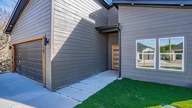 doorway to property with a garage