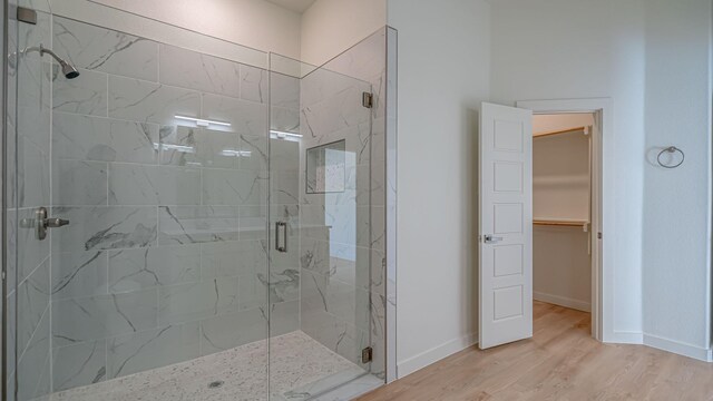 bathroom with wood-type flooring and walk in shower