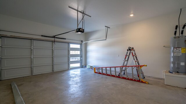 garage featuring electric water heater and a garage door opener