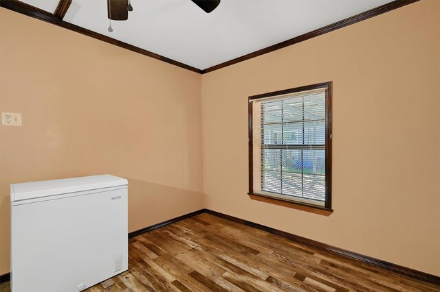 spare room featuring ceiling fan, ornamental molding, and hardwood / wood-style flooring