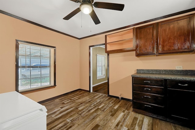 205 N Bean St, Howe, TX 75459 - kitchen with dark countertops, dark wood-style flooring, ornamental molding, ceiling fan, and baseboards