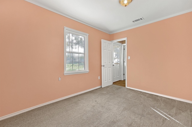 carpeted empty room with ornamental molding