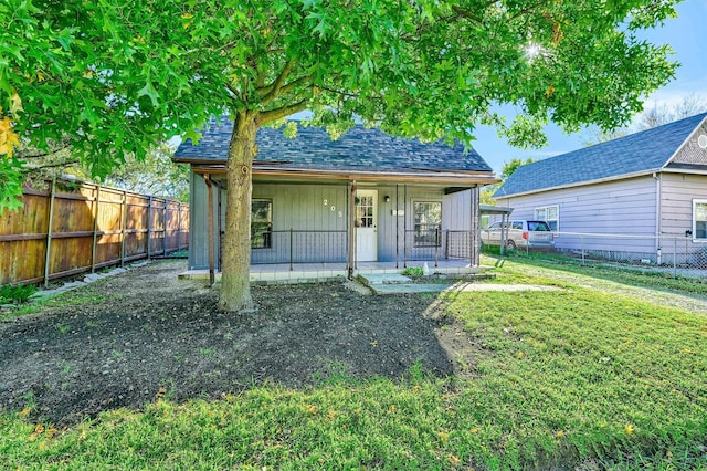 view of outdoor structure featuring covered porch and a lawn