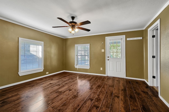 entrance foyer with a textured ceiling, dark hardwood / wood-style floors, ceiling fan, and ornamental molding