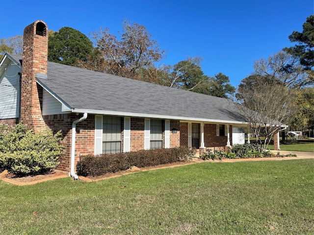 single story home with a front lawn, a chimney, a shingled roof, and brick siding