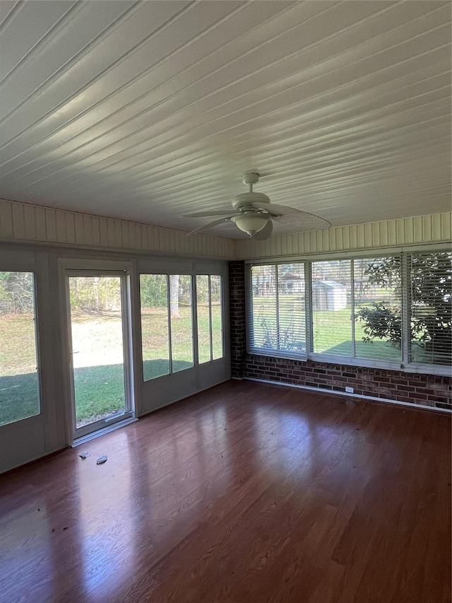 unfurnished sunroom featuring ceiling fan