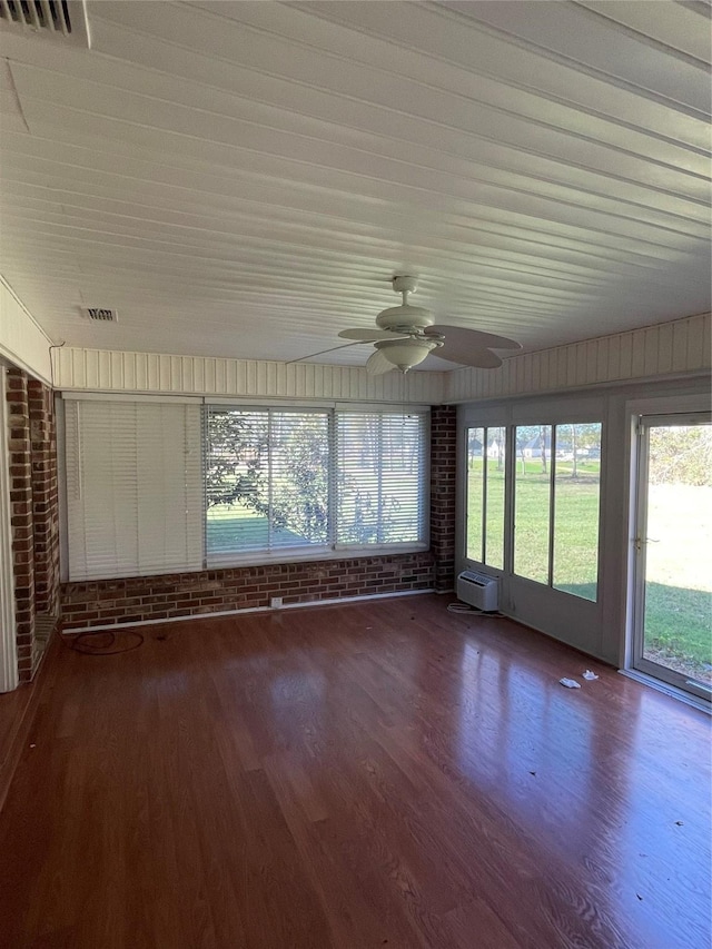 unfurnished sunroom with visible vents and a ceiling fan