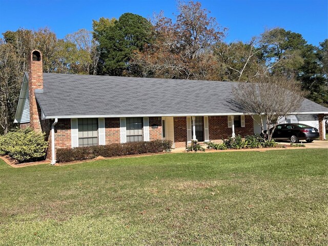 ranch-style house featuring a front yard and a carport