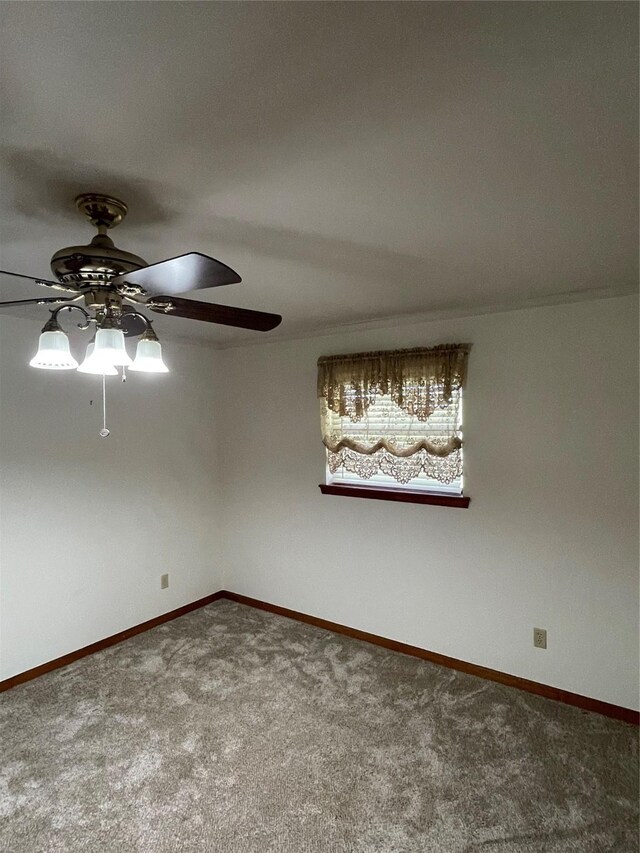 unfurnished room featuring carpet floors, a ceiling fan, and baseboards