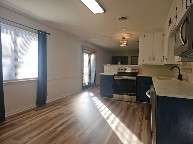 kitchen featuring white cabinets, sink, dark hardwood / wood-style floors, blue cabinetry, and appliances with stainless steel finishes