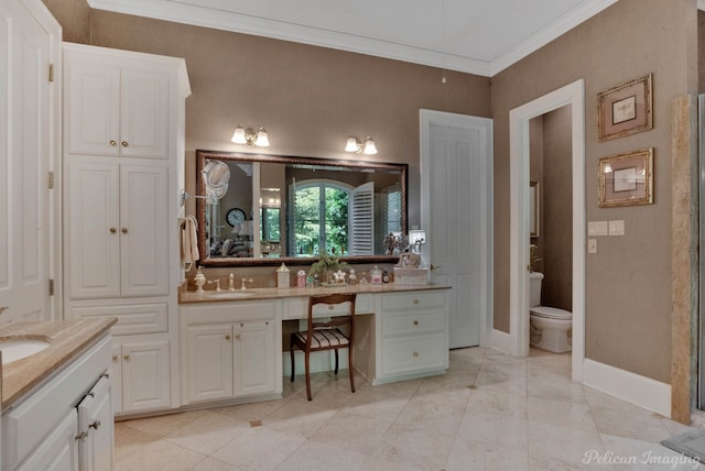 bathroom featuring toilet, vanity, and ornamental molding