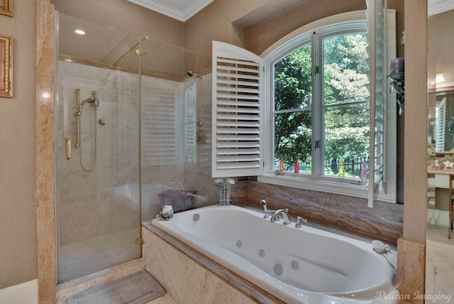 bathroom with ornamental molding and shower with separate bathtub