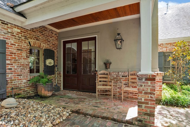 doorway to property featuring a porch and french doors