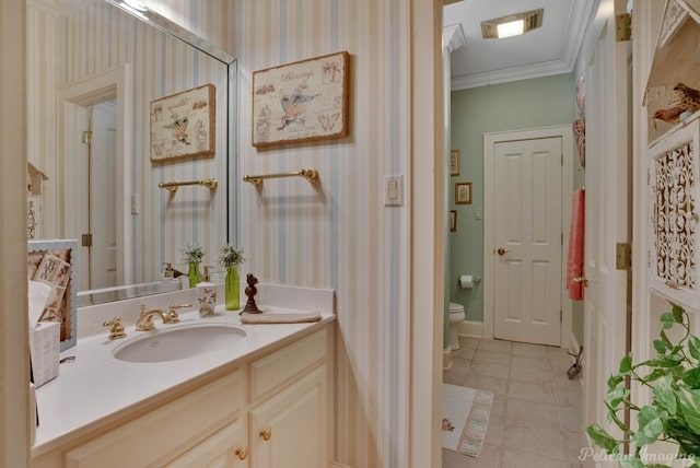 bathroom with tile patterned floors, vanity, toilet, and crown molding