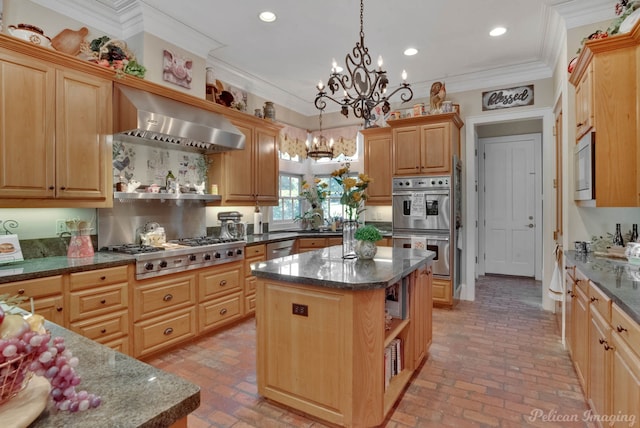 kitchen with ornamental molding, ventilation hood, decorative light fixtures, a kitchen island, and appliances with stainless steel finishes