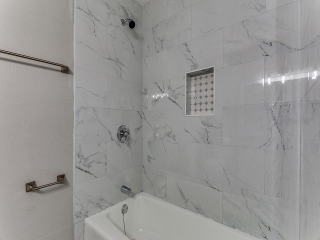 bathroom featuring tiled shower / bath