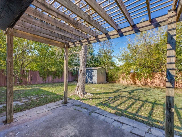 view of patio / terrace with a pergola and a storage unit