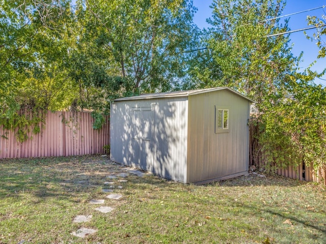 view of outbuilding featuring a yard