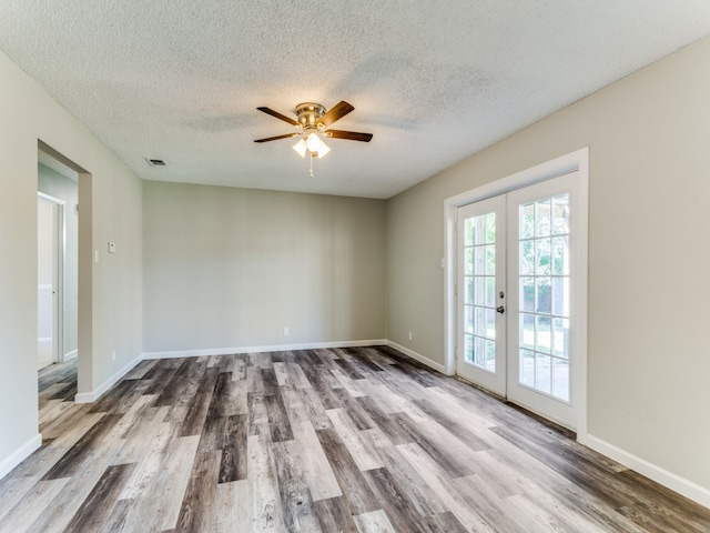 unfurnished room featuring french doors, a textured ceiling, ceiling fan, and hardwood / wood-style floors