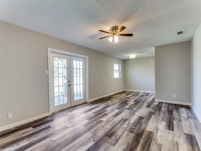 unfurnished room with ceiling fan, french doors, hardwood / wood-style floors, and a textured ceiling