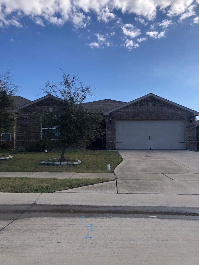 ranch-style house featuring a front yard and a garage