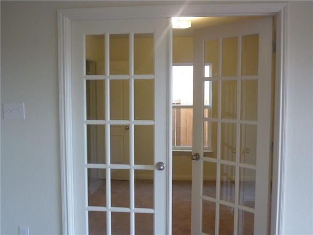 entryway featuring carpet floors and french doors