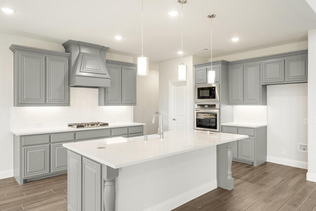 116 Harlan Ct, Aledo, TX 76008 - kitchen featuring appliances with stainless steel finishes, gray cabinetry, wood tiled floors, custom exhaust hood, and recessed lighting