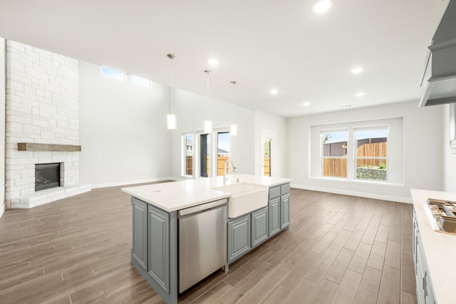 116 Harlan Ct, Aledo, TX 76008 - kitchen with stainless steel appliances, gray cabinetry, open floor plan, light wood-style flooring, and a sink