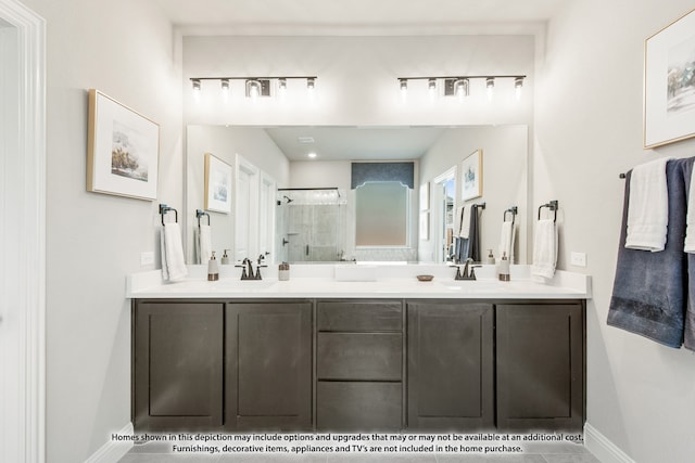 bathroom featuring a shower with door and vanity