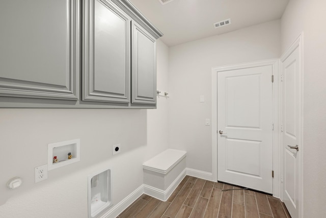 116 Harlan Ct, Aledo, TX 76008 - laundry room featuring electric dryer hookup, cabinet space, dark wood-style flooring, washer hookup, and baseboards