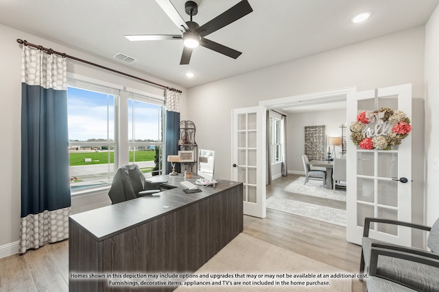 home office featuring french doors, light wood-type flooring, and ceiling fan