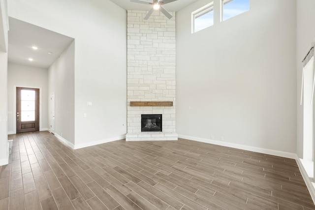 116 Harlan Ct, Aledo, TX 76008 - unfurnished living room with a towering ceiling, ceiling fan, wood finished floors, and baseboards