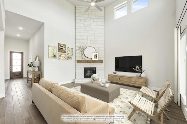 116 Harlan Ct, Aledo, TX 76008 - living room with a towering ceiling, ceiling fan, baseboards, wood finished floors, and a stone fireplace
