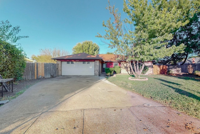 ranch-style home with a front yard and a garage