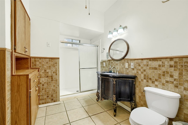 bathroom featuring tile patterned flooring, tile walls, and a shower with shower door