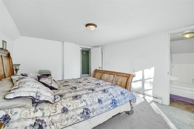 carpeted bedroom with a baseboard heating unit, a textured ceiling, and ensuite bath