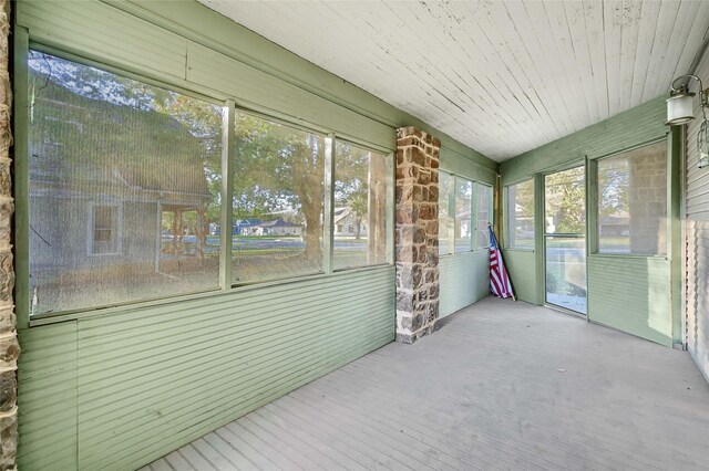 unfurnished sunroom featuring wood ceiling